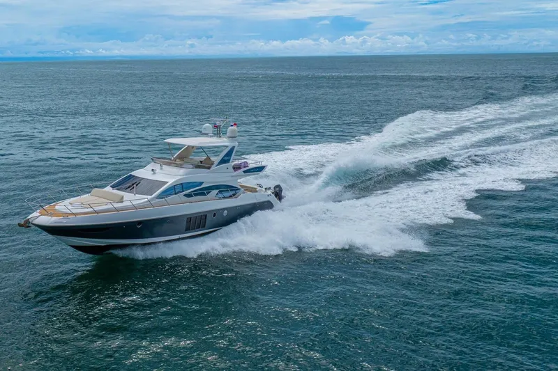 Costa Luna Yacht Photos Pics Luxurious 2014 Azimut 64 yacht cruising on open sea under clear skies.