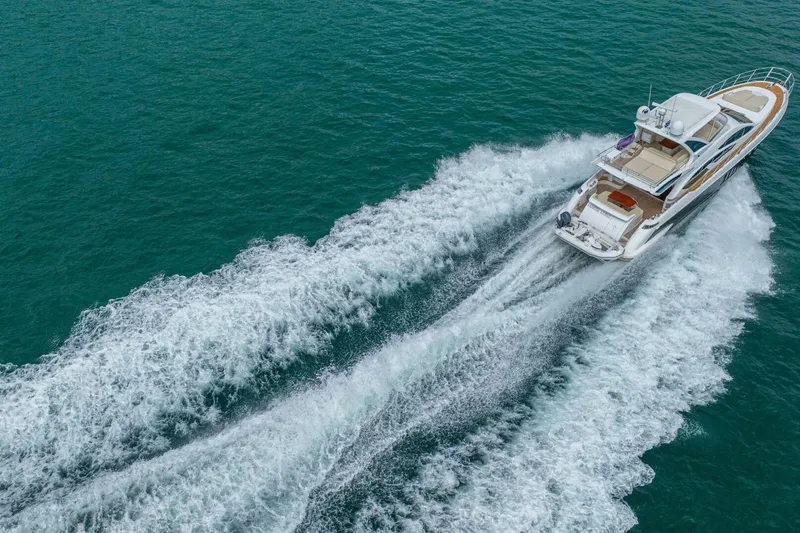 Costa Luna Yacht Photos Pics Aerial view of 2014 Azimut 64 yacht cruising on open water.