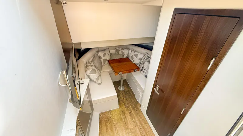 Black Diamond Yacht Photos Pics 2022 Cruisers Yachts 38 GLS interior with cozy seating and wooden table.
