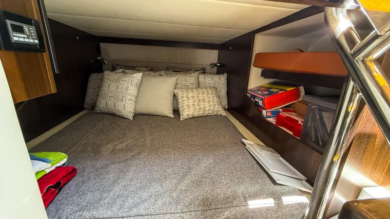 Black Diamond Yacht Photos Pics 2022 Cruisers Yachts 38 GLS cabin interior with bed and storage shelves.
