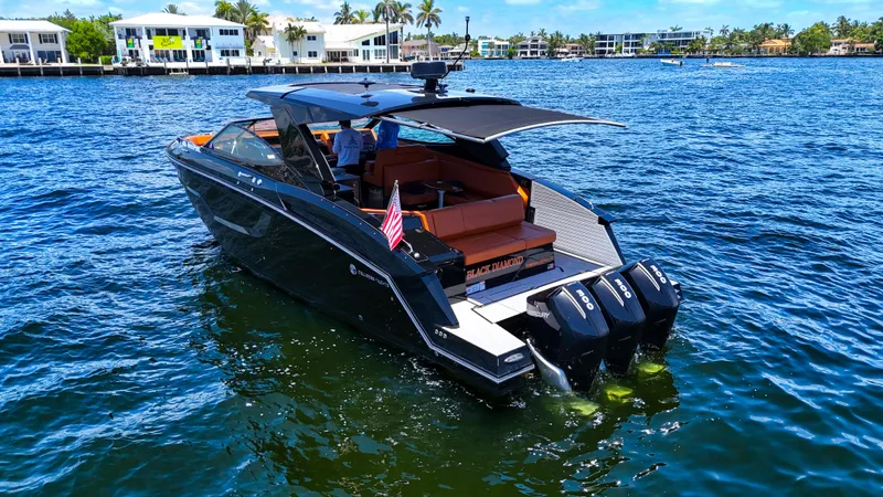 Black Diamond Yacht Photos Pics 2022 Cruisers Yachts 38 GLS luxury boat on water, featuring triple Mercury engines.