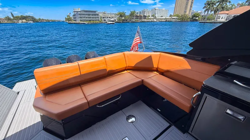 Black Diamond Yacht Photos Pics Luxurious 2022 Cruisers Yachts 38 GLS with tan seating, docked by scenic waterfront.