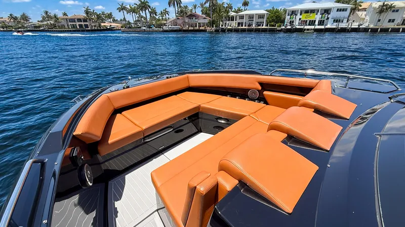 Black Diamond Yacht Photos Pics 2022 Cruisers Yachts 38 GLS with orange seating on a sunny waterfront.