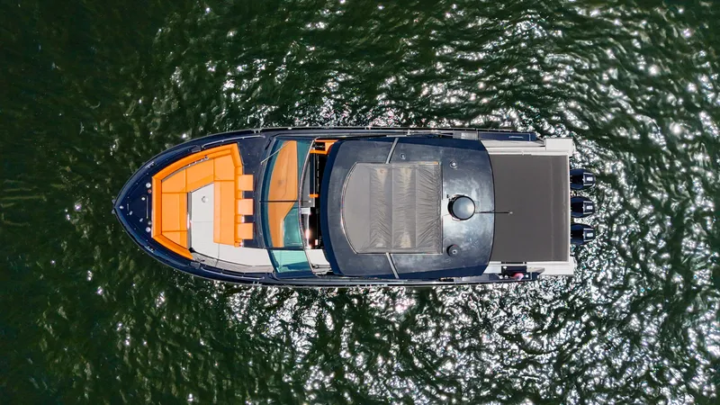 Black Diamond Yacht Photos Pics Aerial view of 2022 Cruisers Yachts 38 GLS on shimmering water.