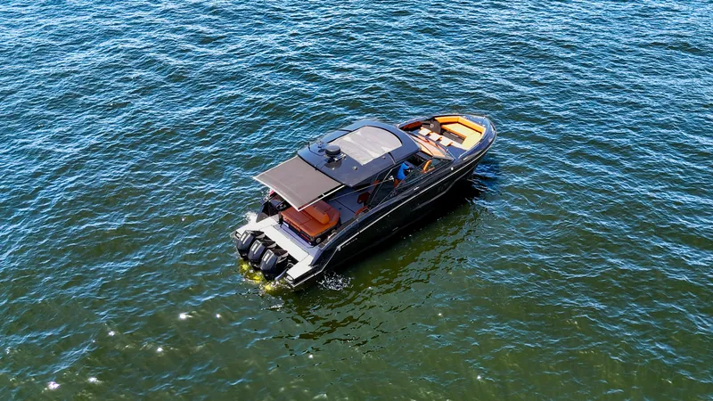 Black Diamond Yacht Photos Pics 2022 Cruisers Yachts 38 GLS on open water, aerial view.