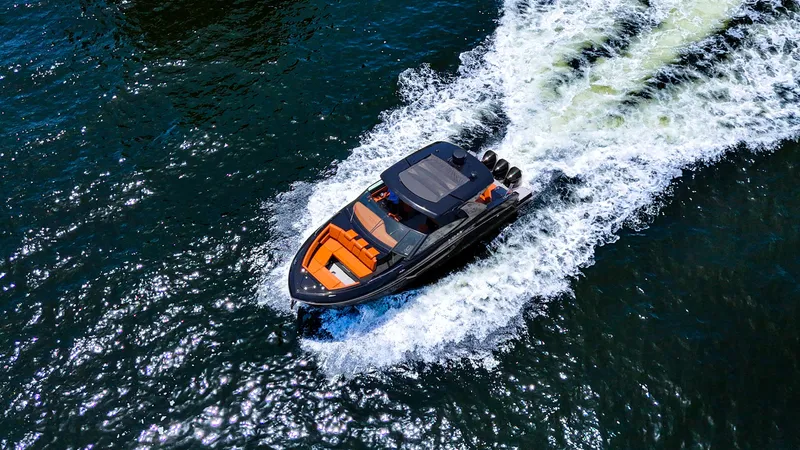 Black Diamond Yacht Photos Pics 2022 Cruisers Yachts 38 GLS speeding on open water, aerial view.