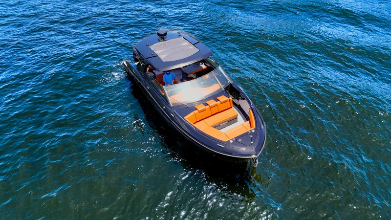 Black Diamond Yacht Photos Pics 2022 Cruisers Yachts 38 GLS on open water, featuring sleek design and vibrant seating.