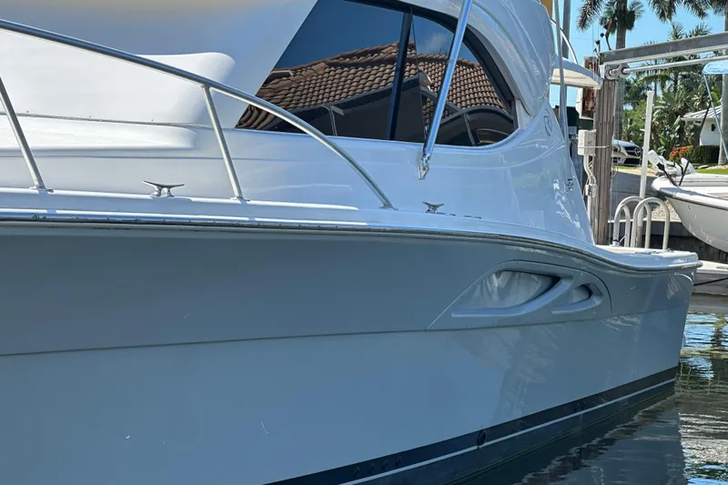 Game On Yacht Photos Pics 2002 Riviera 40 Flybridge yacht docked, showcasing sleek design and polished exterior.