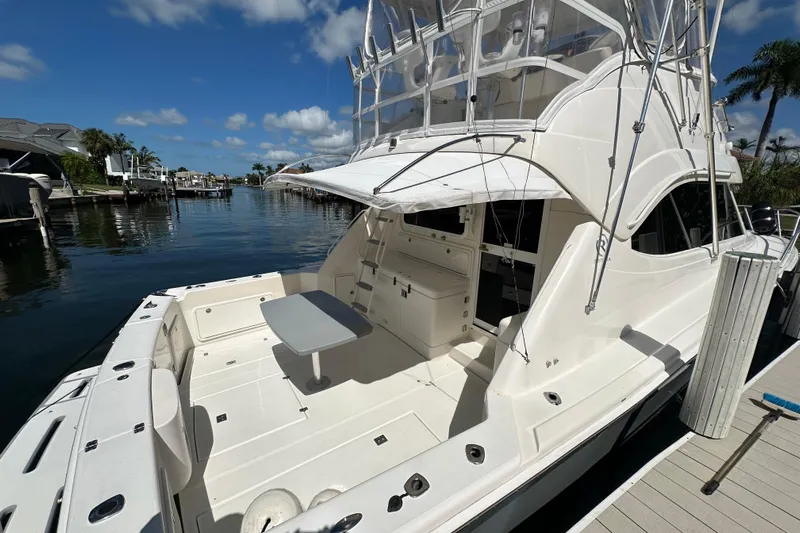 Game On Yacht Photos Pics Riviera 40 Flybridge 2002 yacht docked, featuring spacious deck and flybridge under clear skies.