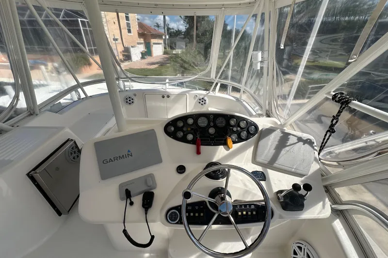 Game On Yacht Photos Pics Cockpit of 2002 Riviera 40 Flybridge with Garmin navigation system and steering wheel.