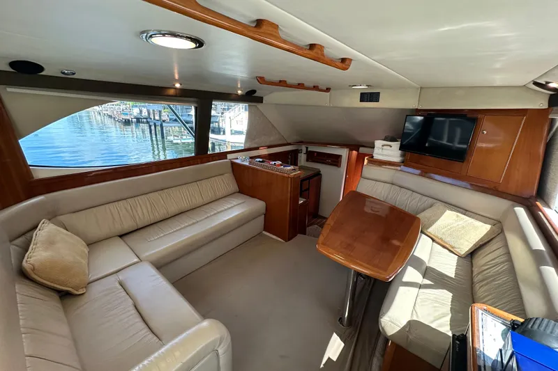 Game On Yacht Photos Pics Luxurious interior of 2002 Riviera 40 Flybridge yacht with plush seating and wooden accents.