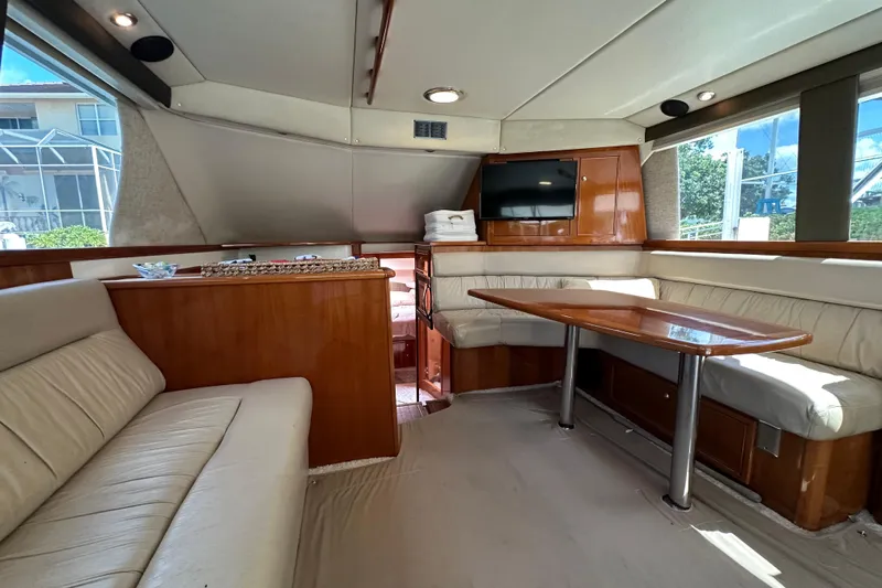 Game On Yacht Photos Pics Luxurious interior of 2002 Riviera 40 Flybridge yacht with elegant seating and dining area.