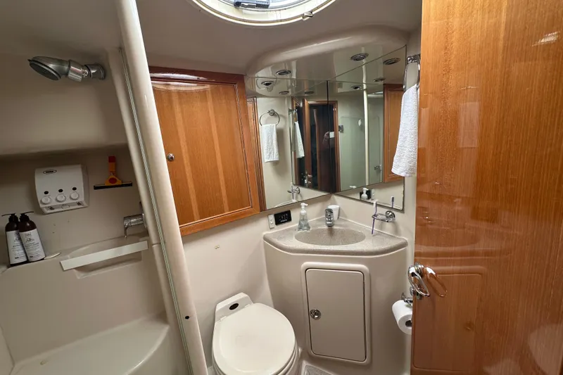 Game On Yacht Photos Pics Bathroom interior of 2002 Riviera 40 Flybridge yacht, featuring sink, toilet, and shower.