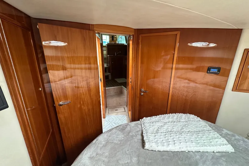 Game On Yacht Photos Pics Interior of 2002 Riviera 40 Flybridge yacht with polished wood doors and cozy cabin.