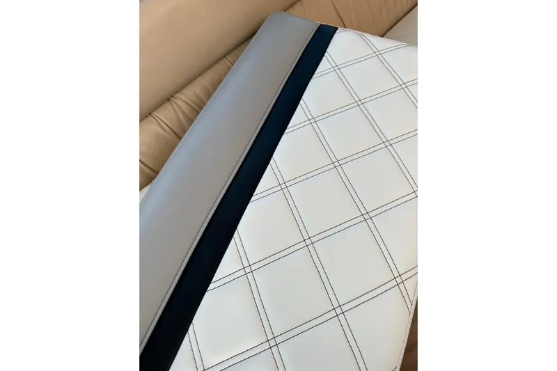 Game On Yacht Photos Pics Close-up of 2002 Riviera 40 Flybridge interior upholstery with checkered pattern.