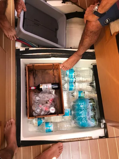  Yacht Photos Pics Storage compartment on Jeanneau Sun Odyssey 409 yacht with water bottles and wine.