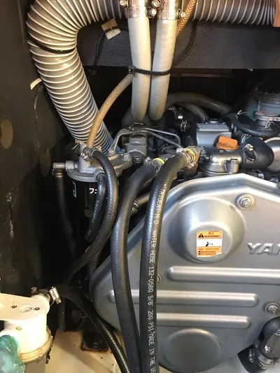  Yacht Photos Pics Engine compartment of a 2011 Jeanneau Sun Odyssey 409 sailboat, featuring hoses and mechanical components.