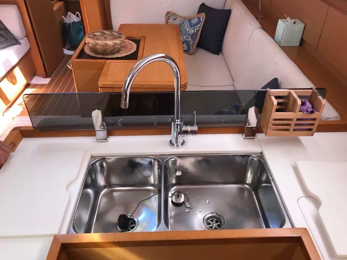  Yacht Photos Pics Jeanneau Sun Odyssey 409 yacht interior, featuring a modern kitchen sink and cozy seating area.