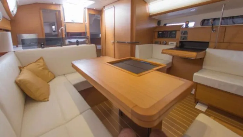  Yacht Photos Pics Interior of 2011 Jeanneau Sun Odyssey 409 yacht with wooden furnishings and cozy seating.