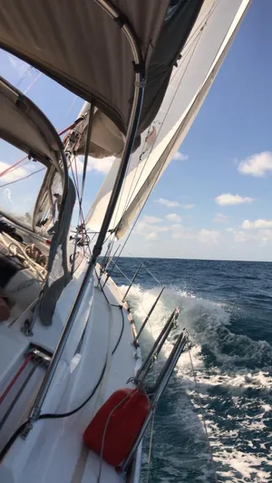  Yacht Photos Pics Jeanneau Sun Odyssey 409 sailing on open sea, 2011 model, with clear skies and ocean waves.