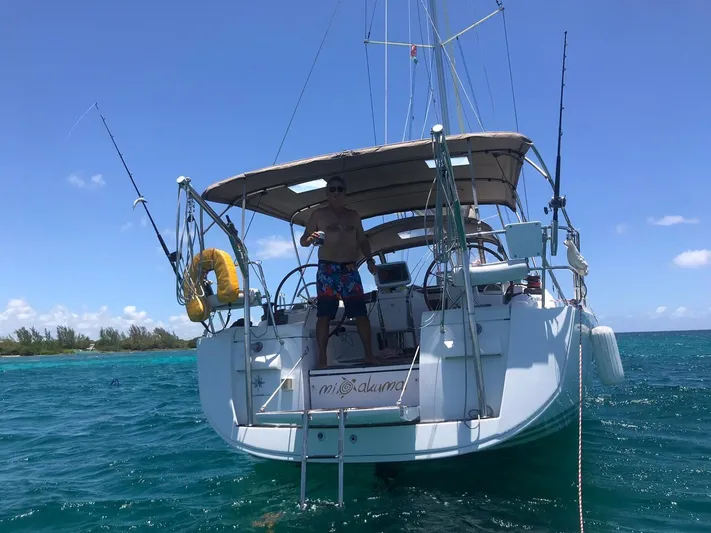  Yacht Photos Pics 2011 Jeanneau Sun Odyssey 409 sailboat anchored in clear blue water.