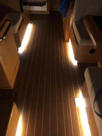  Yacht Photos Pics Interior of 2011 Jeanneau Sun Odyssey 409 yacht with illuminated wooden flooring.