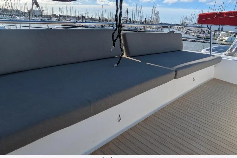  Yacht Photos Pics Spacious seating area on 2018 NEEL 51 yacht, docked at marina with sailboats.