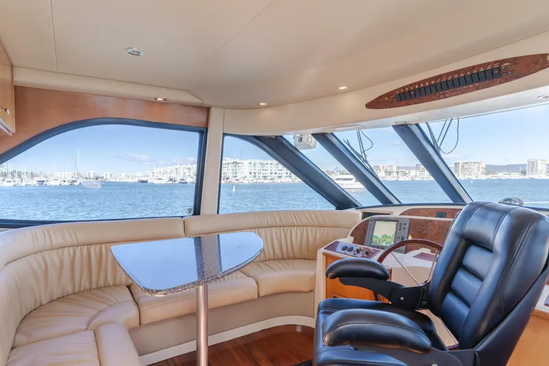 Jolie Vie Yacht Photos Pics Luxurious interior of 2004 Meridian 540 Pilothouse yacht with panoramic windows and leather seating.