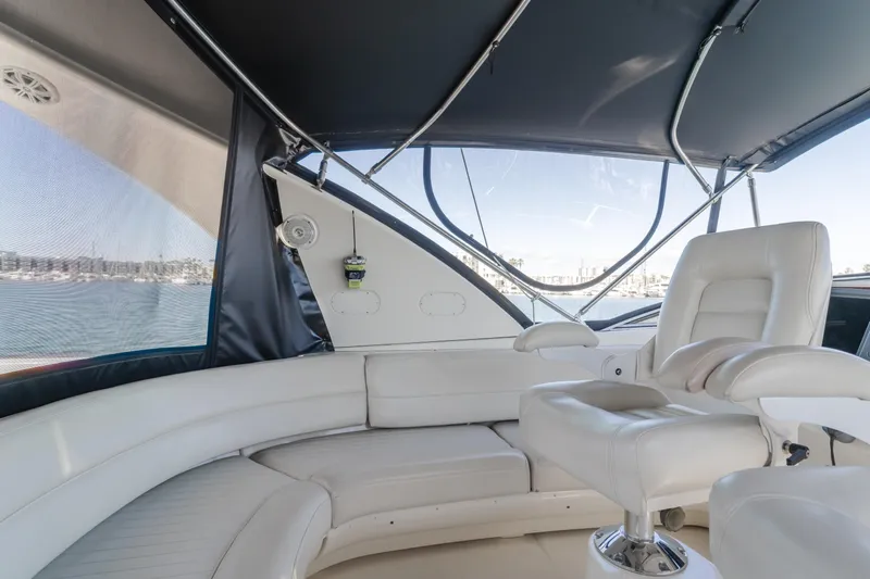 Jolie Vie Yacht Photos Pics Interior of 2004 Meridian 540 Pilothouse yacht with white seating and panoramic windows.