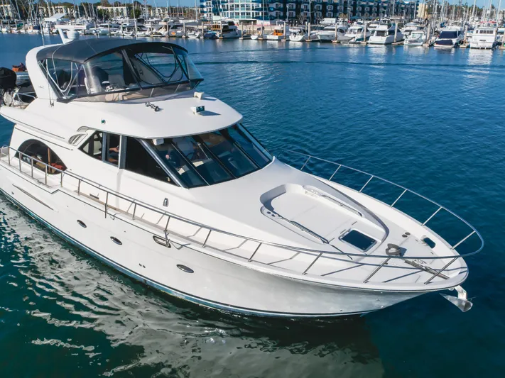 Jolie Vie Yacht Photos Pics 2004 Meridian 540 Pilothouse yacht docked in a marina, surrounded by water and other boats.