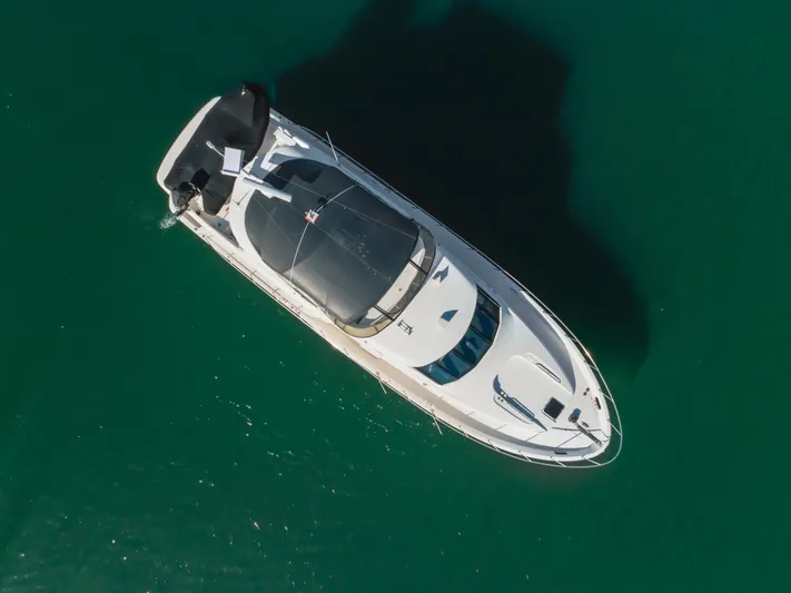 Jolie Vie Yacht Photos Pics Aerial view of 2004 Meridian 540 Pilothouse yacht on clear green water.