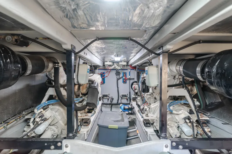 Jolie Vie Yacht Photos Pics Engine room of 2004 Meridian 540 Pilothouse yacht, showcasing dual engines and mechanical systems.