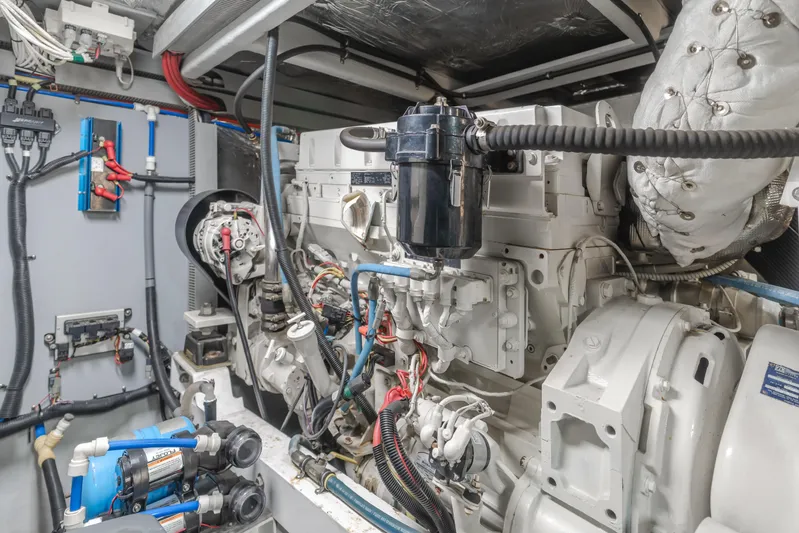 Jolie Vie Yacht Photos Pics Engine room of a 2004 Meridian 540 Pilothouse yacht, showcasing complex machinery and wiring.
