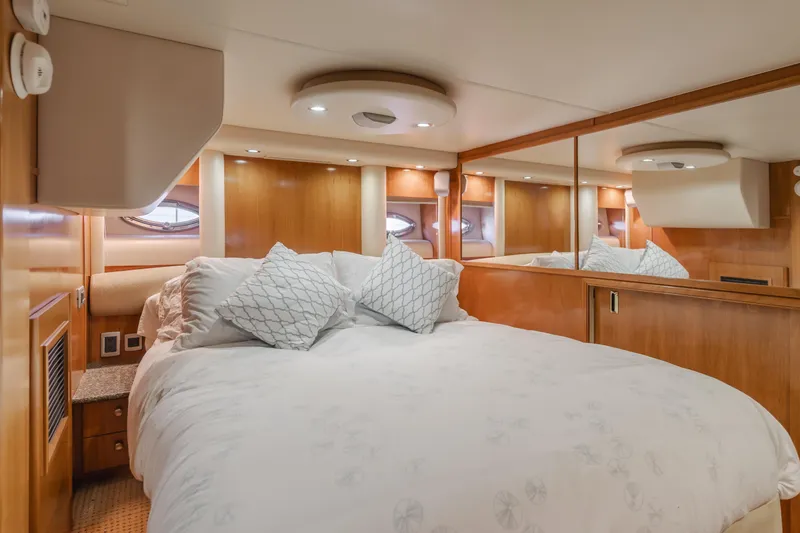 Jolie Vie Yacht Photos Pics Luxurious bedroom interior of 2004 Meridian 540 Pilothouse yacht with elegant bedding.