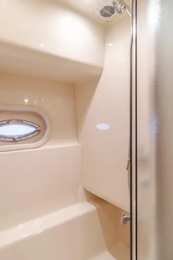 Jolie Vie Yacht Photos Pics 2004 Meridian 540 Pilothouse shower interior with oval window and modern fixtures.