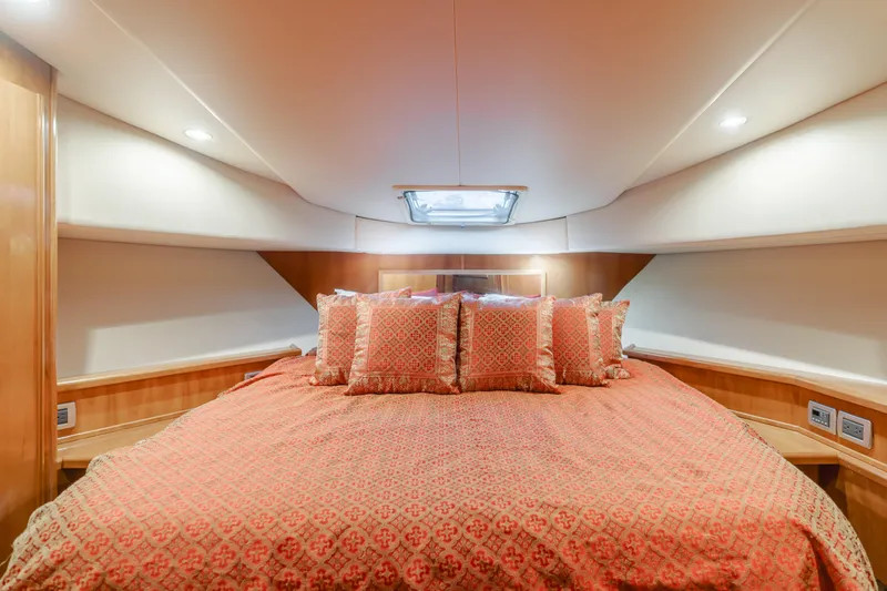 Jolie Vie Yacht Photos Pics Luxurious bedroom in 2004 Meridian 540 Pilothouse yacht with elegant bedding and ambient lighting.
