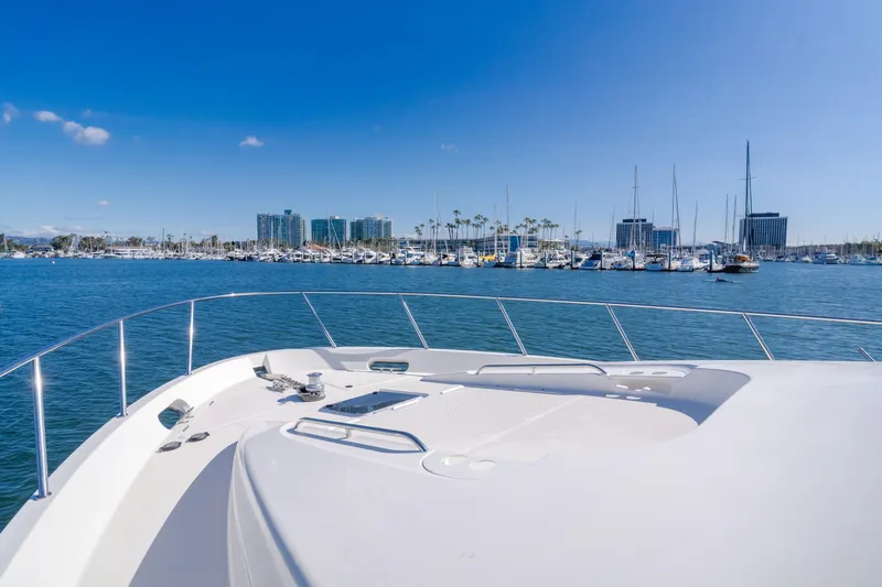 Jolie Vie Yacht Photos Pics 2004 Meridian 540 Pilothouse yacht cruising near a marina under clear blue skies.