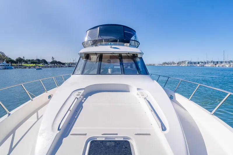 Jolie Vie Yacht Photos Pics 2004 Meridian 540 Pilothouse yacht on calm water, clear sky, marina in background.