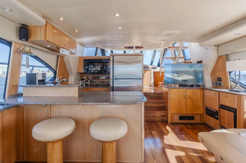 Jolie Vie Yacht Photos Pics Luxurious interior of 2004 Meridian 540 Pilothouse yacht with modern kitchen and seating area.