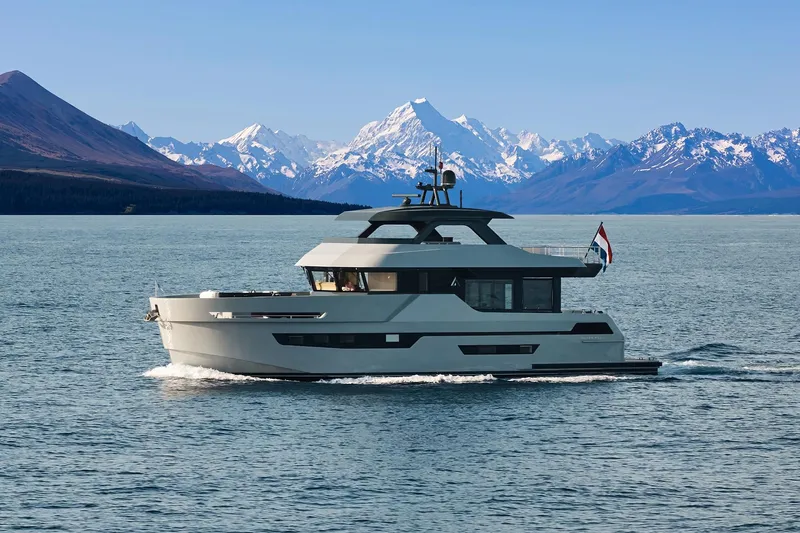  Yacht Photos Pics 2026 Outer Reef Yachts 780 Adventure cruising with snowy mountain backdrop.