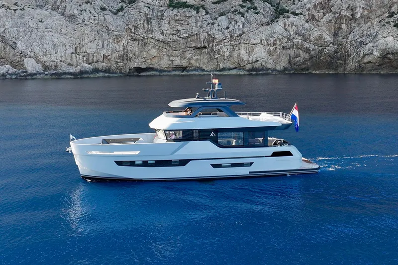  Yacht Photos Pics 2026 Outer Reef Yachts 780 Adventure cruising near rocky coastline.