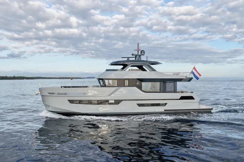  Yacht Photos Pics 2026 Outer Reef Yachts 780 Adventure cruising on calm waters under a cloudy sky.