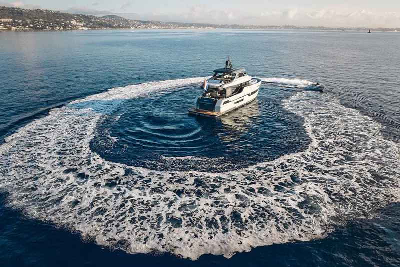  Yacht Photos Pics 2026 Outer Reef Yachts 780 Adventure cruising in open sea, creating circular wake pattern.