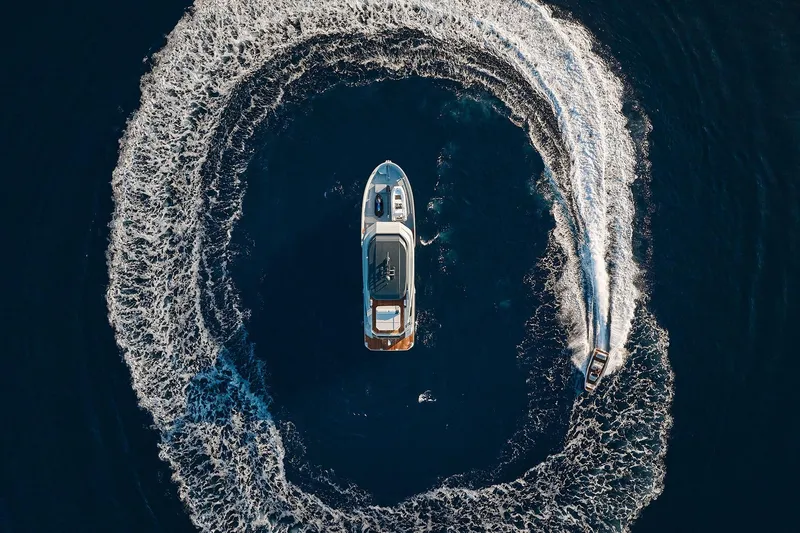  Yacht Photos Pics Aerial view of 2026 Outer Reef Yachts 780 Adventure surrounded by a speedboat's wake.