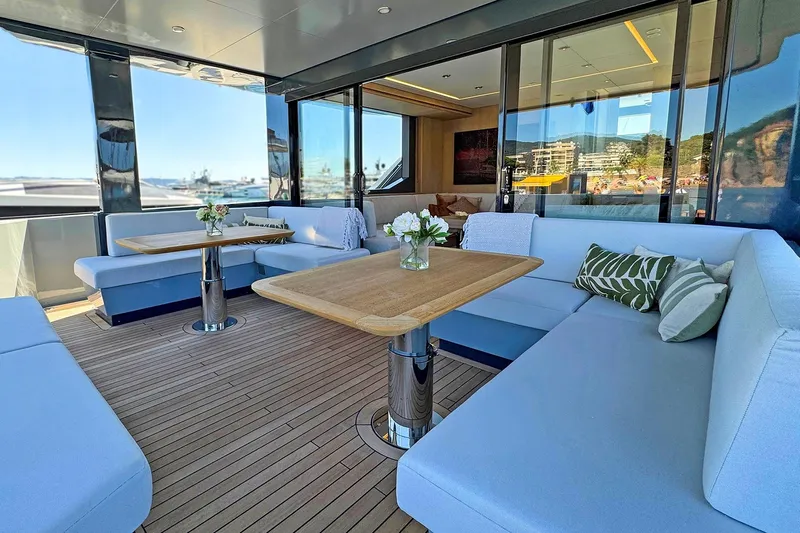  Yacht Photos Pics Luxurious 2026 Outer Reef Yachts 780 Adventure deck with elegant seating and tables.