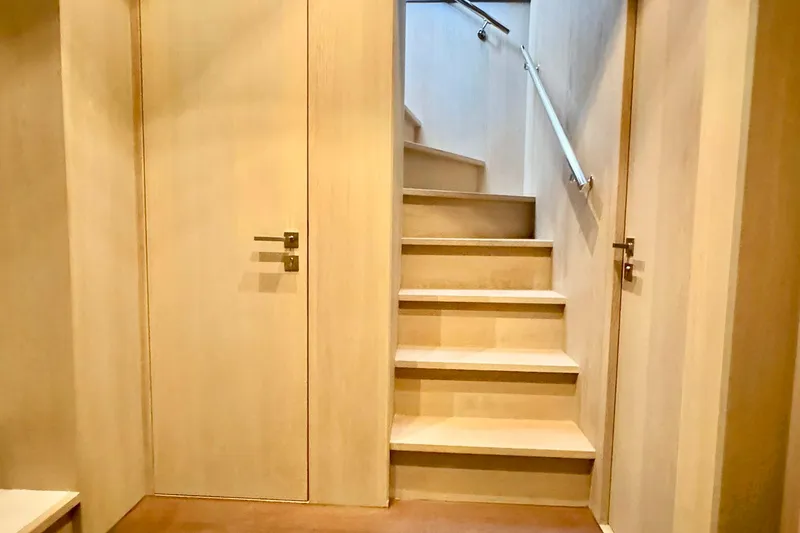  Yacht Photos Pics Interior stairs of 2026 Outer Reef Yachts 780 Adventure, featuring wooden finish and modern design.