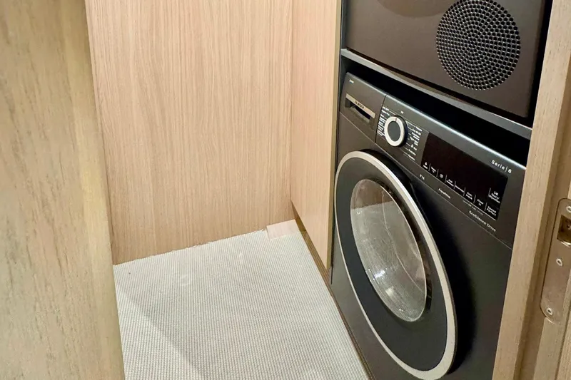  Yacht Photos Pics Laundry area in 2026 Outer Reef Yachts 780 Adventure, featuring modern washer and dryer.