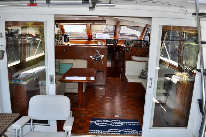 Freakin' Awesome Yacht Photos Pics Interior view of 1990 Ocean Alexander 42 Sedan yacht, featuring wood finishes and seating area.