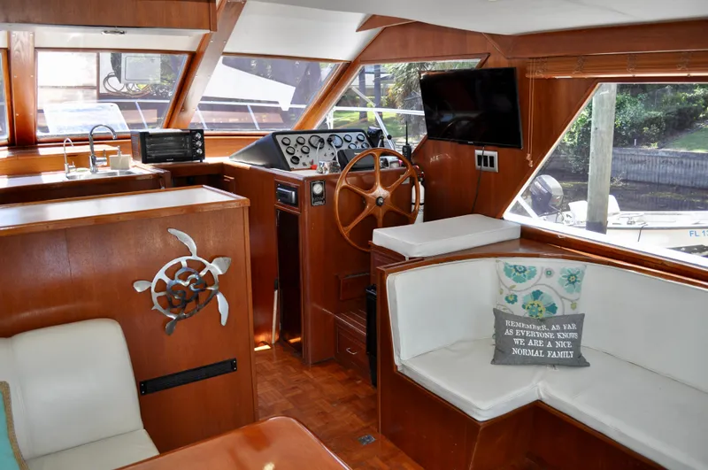 Freakin' Awesome Yacht Photos Pics Interior of a 1990 Ocean Alexander 42 Sedan yacht with wood paneling and steering wheel.