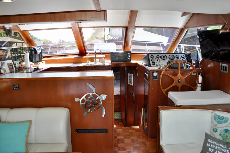 Freakin' Awesome Yacht Photos Pics Interior of 1990 Ocean Alexander 42 Sedan yacht with wooden helm and seating area.